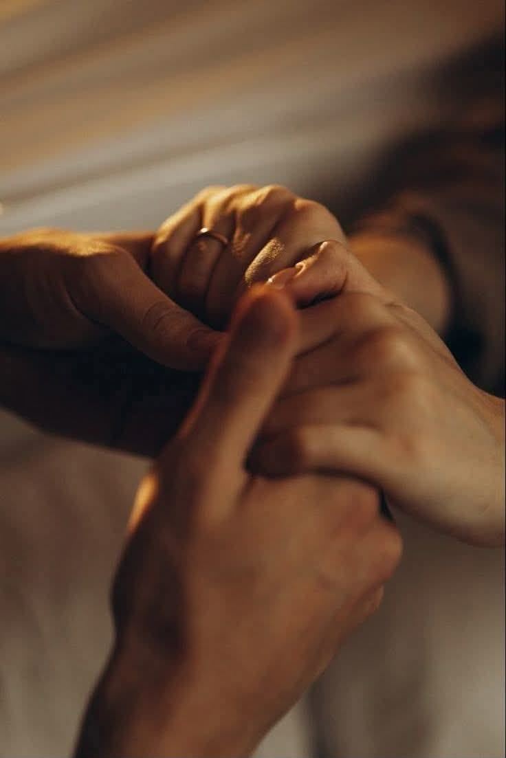 Mãos entrelaçadas em luz quente